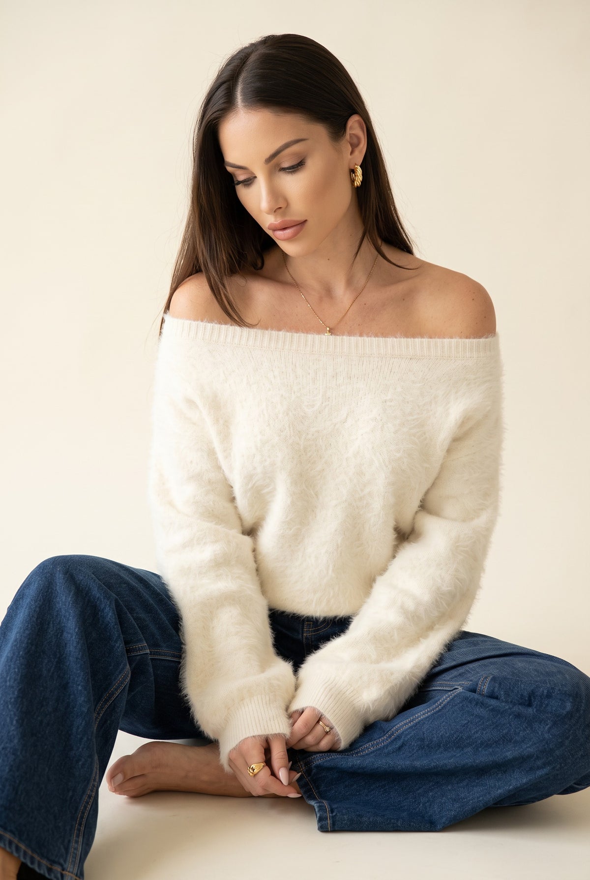 White plush strapless sweater, seated