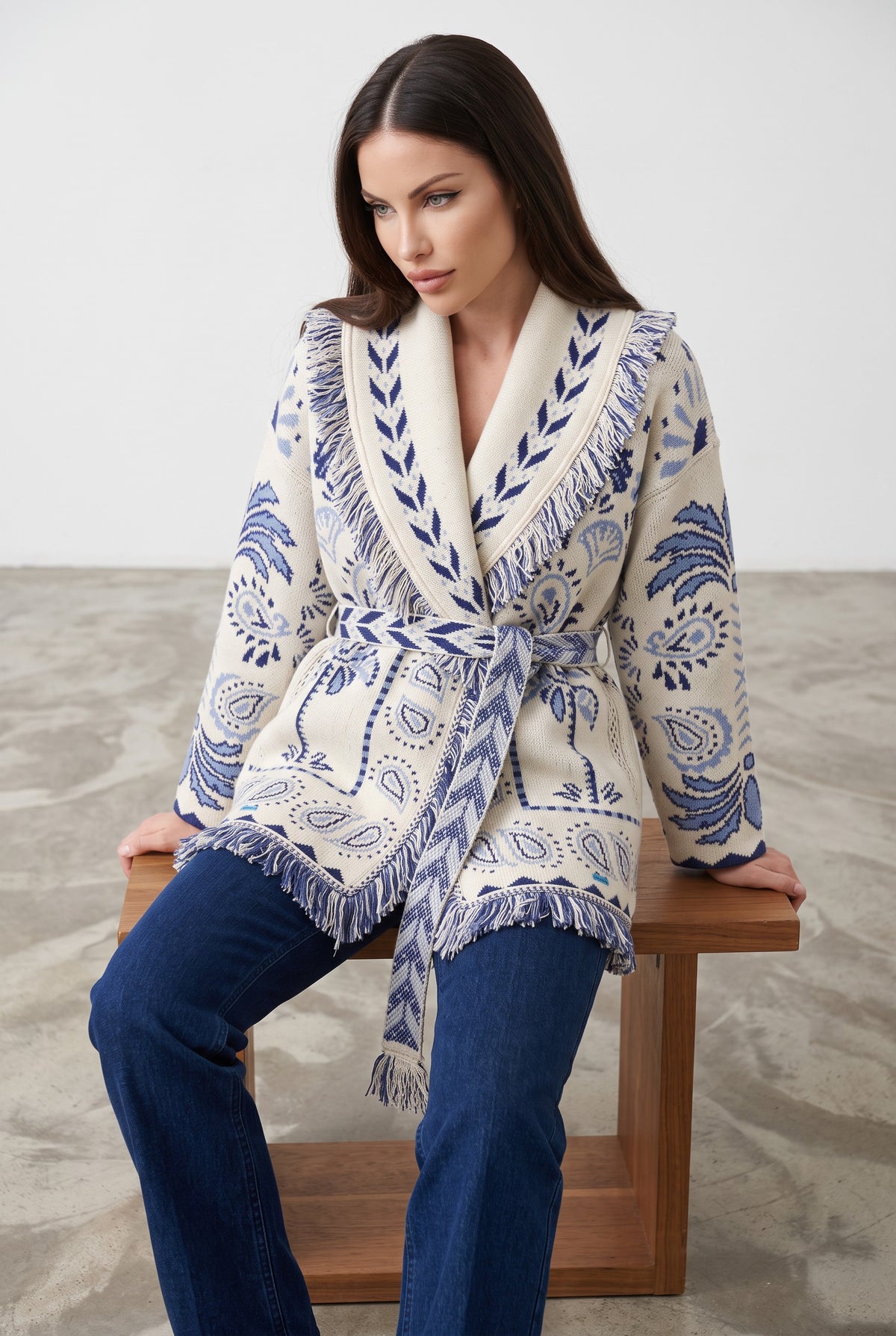 Light Blue & Navy knitted patchwork cardigan, seated