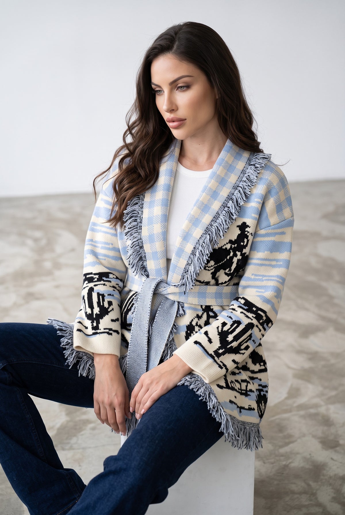 Light Blue & Black knitted patchwork cardigan, seated