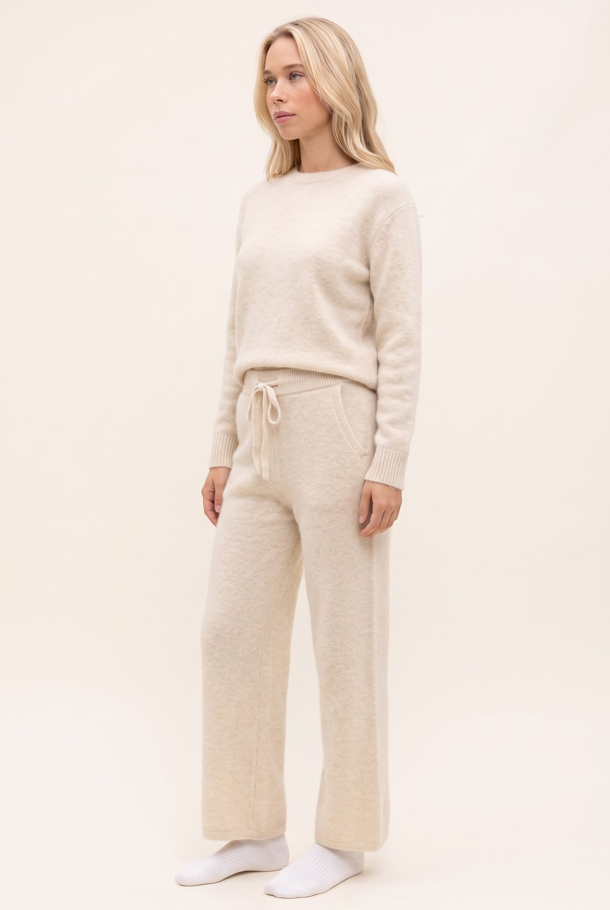 White cashmere trousers, standing